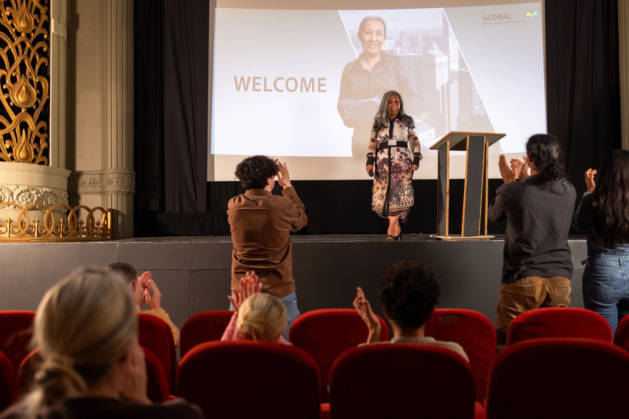 Audience reacting positively during a business conference session